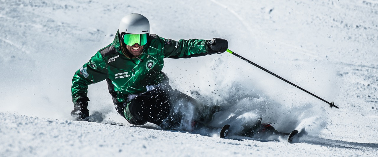 Ski instructor that performs a carving turn while smiling