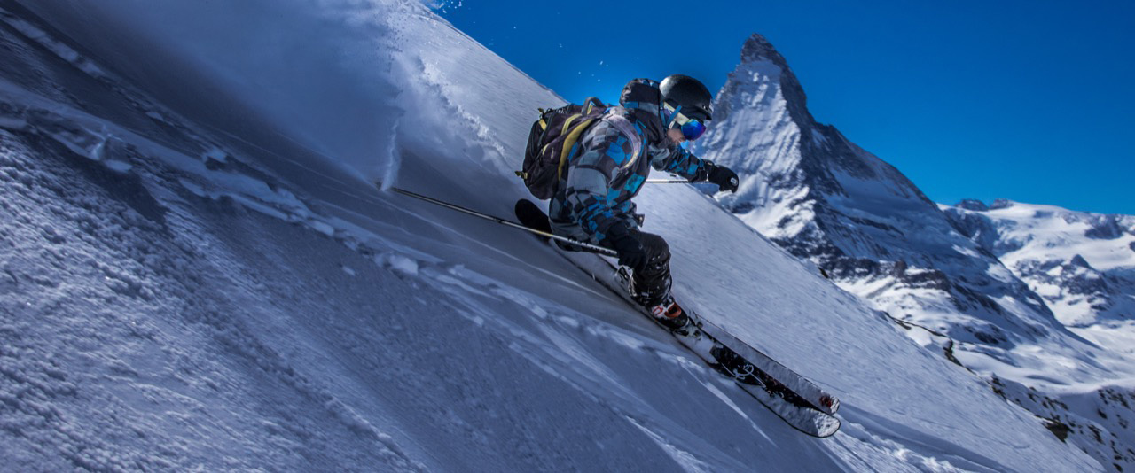 Ski instructor skiing off piste with the Matterhorn in the background